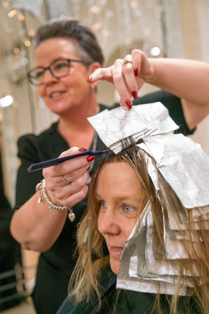 A Riverhills stylist working with a client in the hair salon