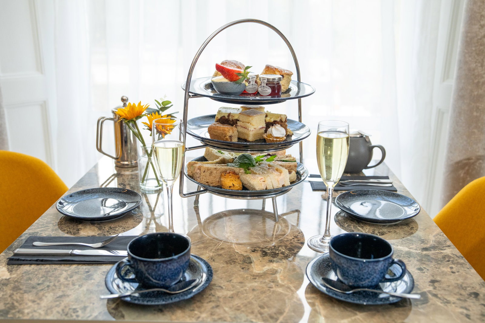 Afternoon tea served with sandwiches, cakes and tea